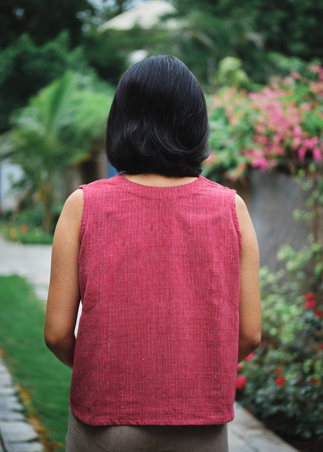 back view of a woman in a red sleeveless top