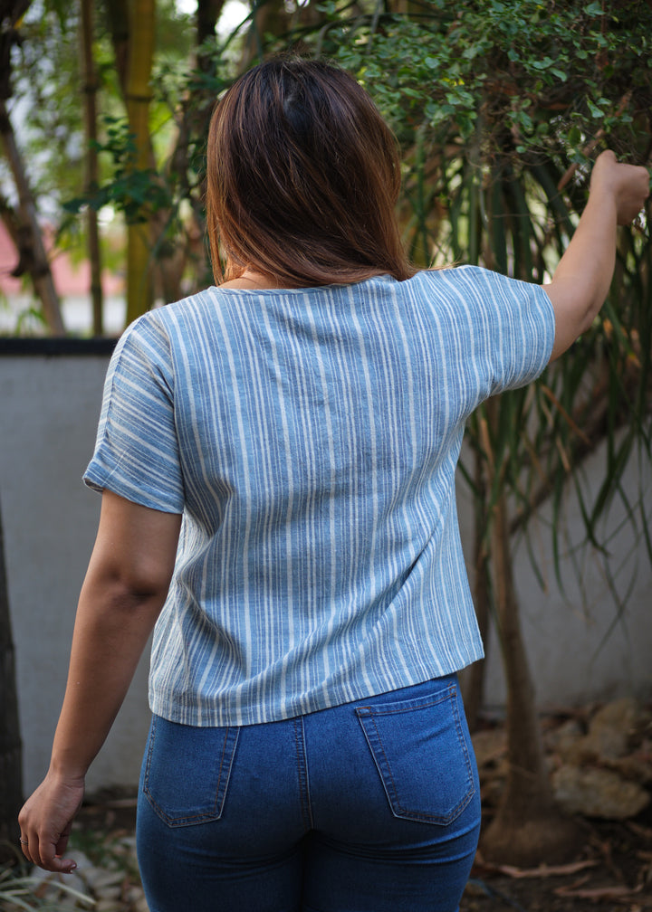 a woman wearing a blue shirt - back view