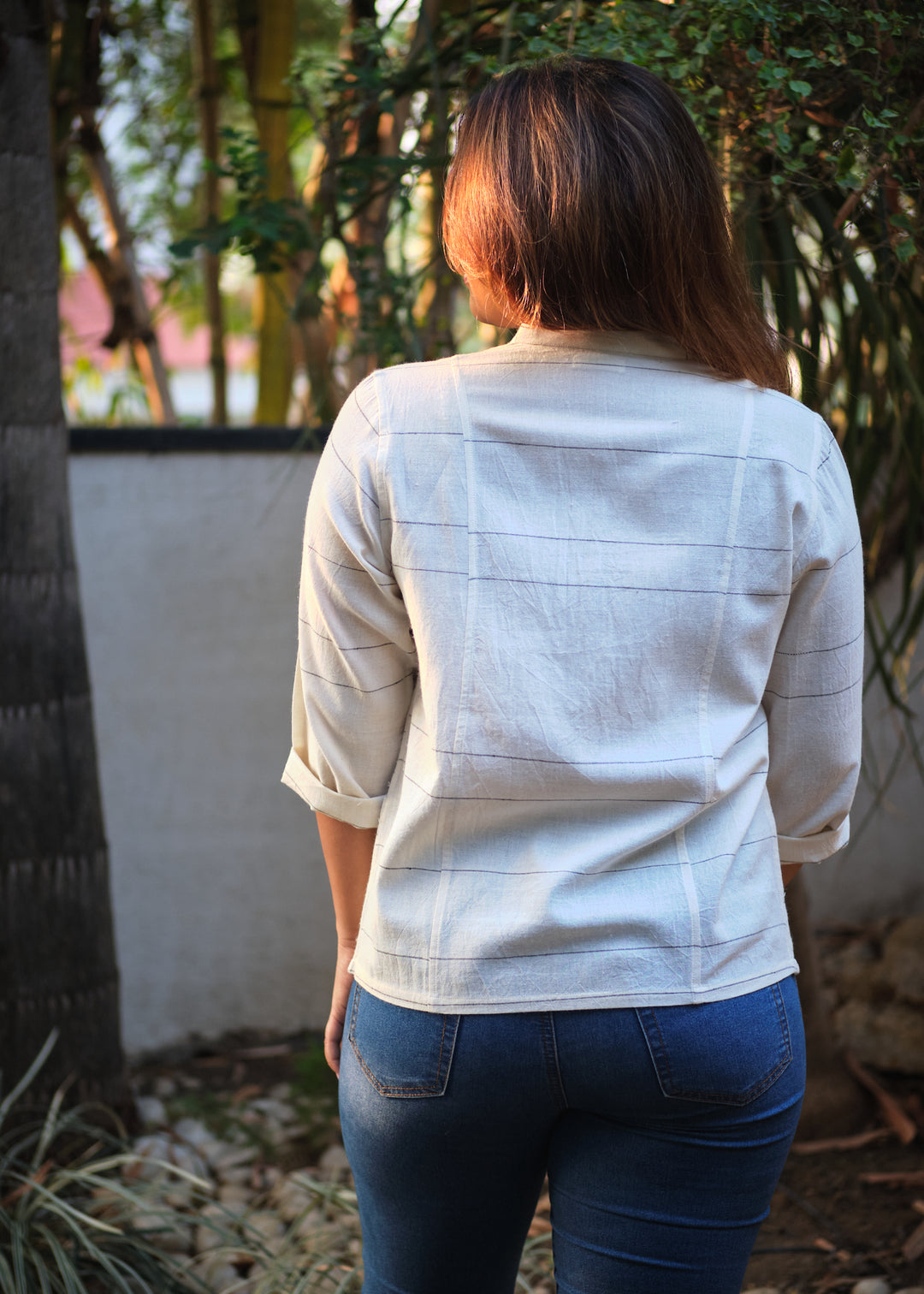 rear profile of a woman in a white shirt