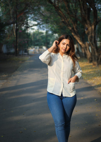 woman in a white shirt walking on a road